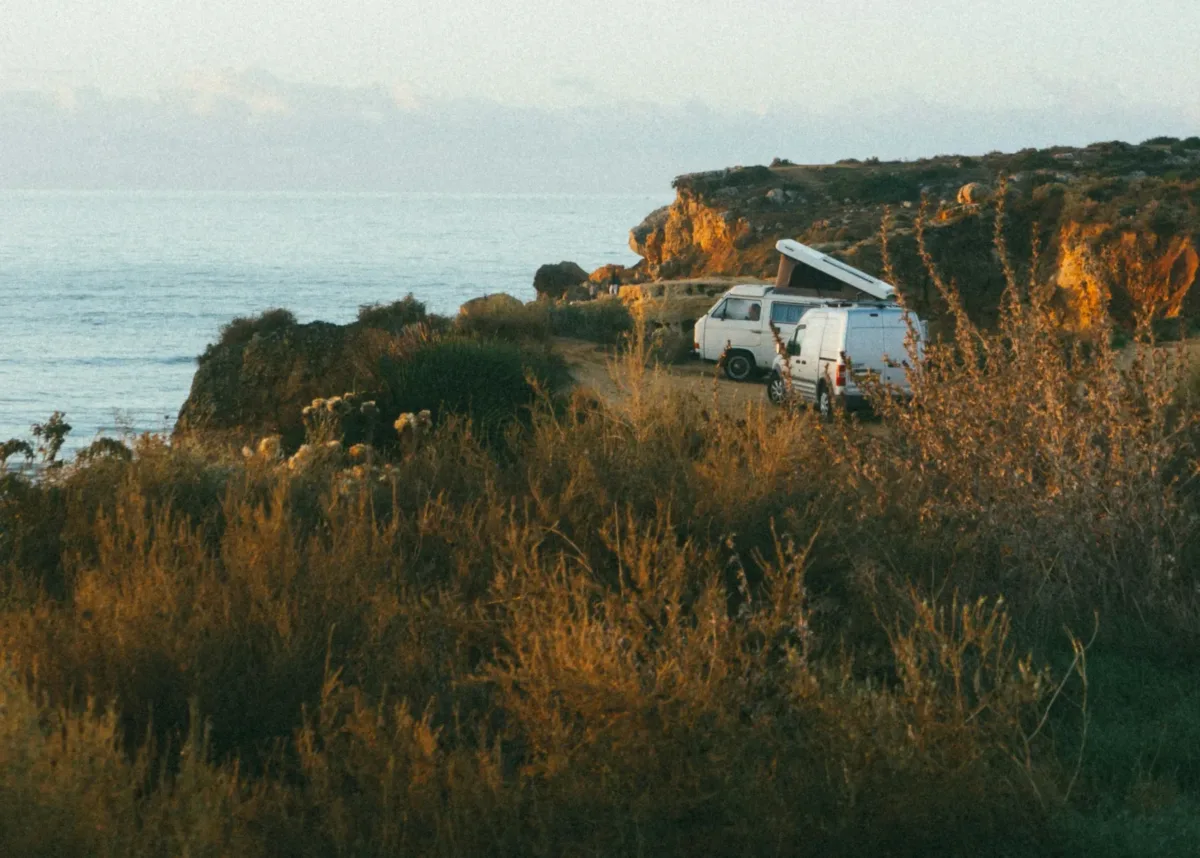 white van near cliff during daytime